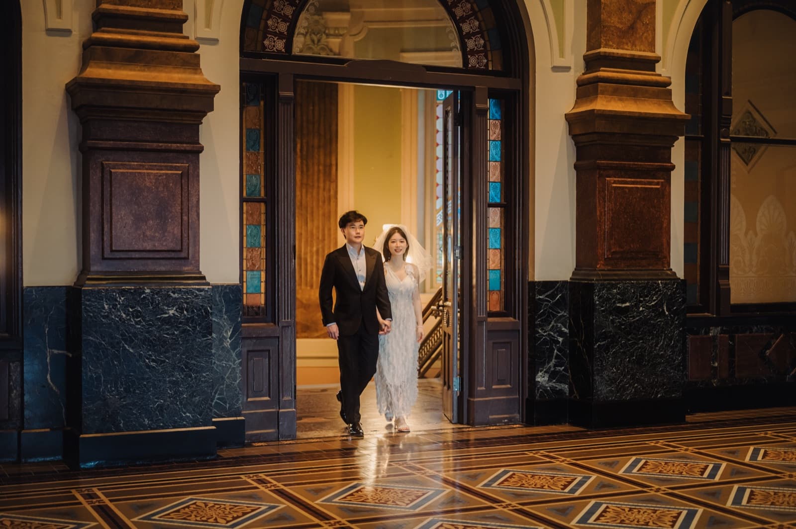 Couple walking through an ornate doorway