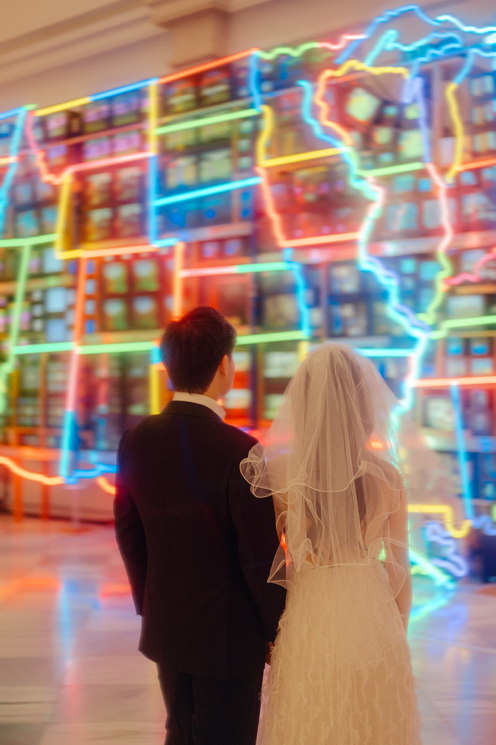 Couple viewing a neon map art installation