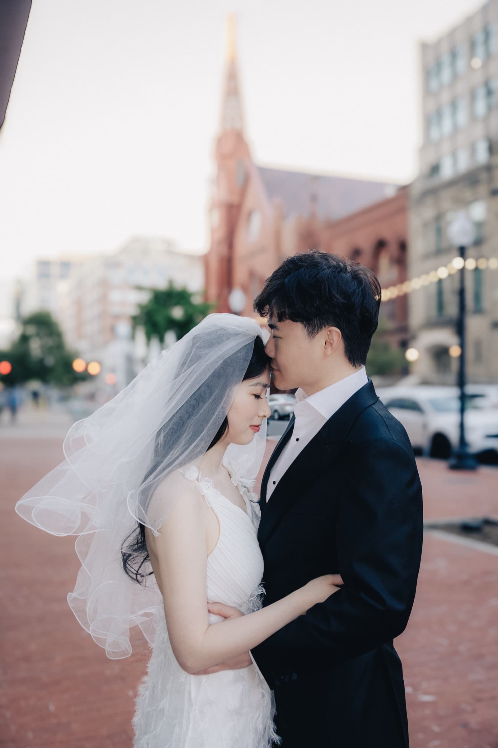 Couple embracing on a city street at sunset